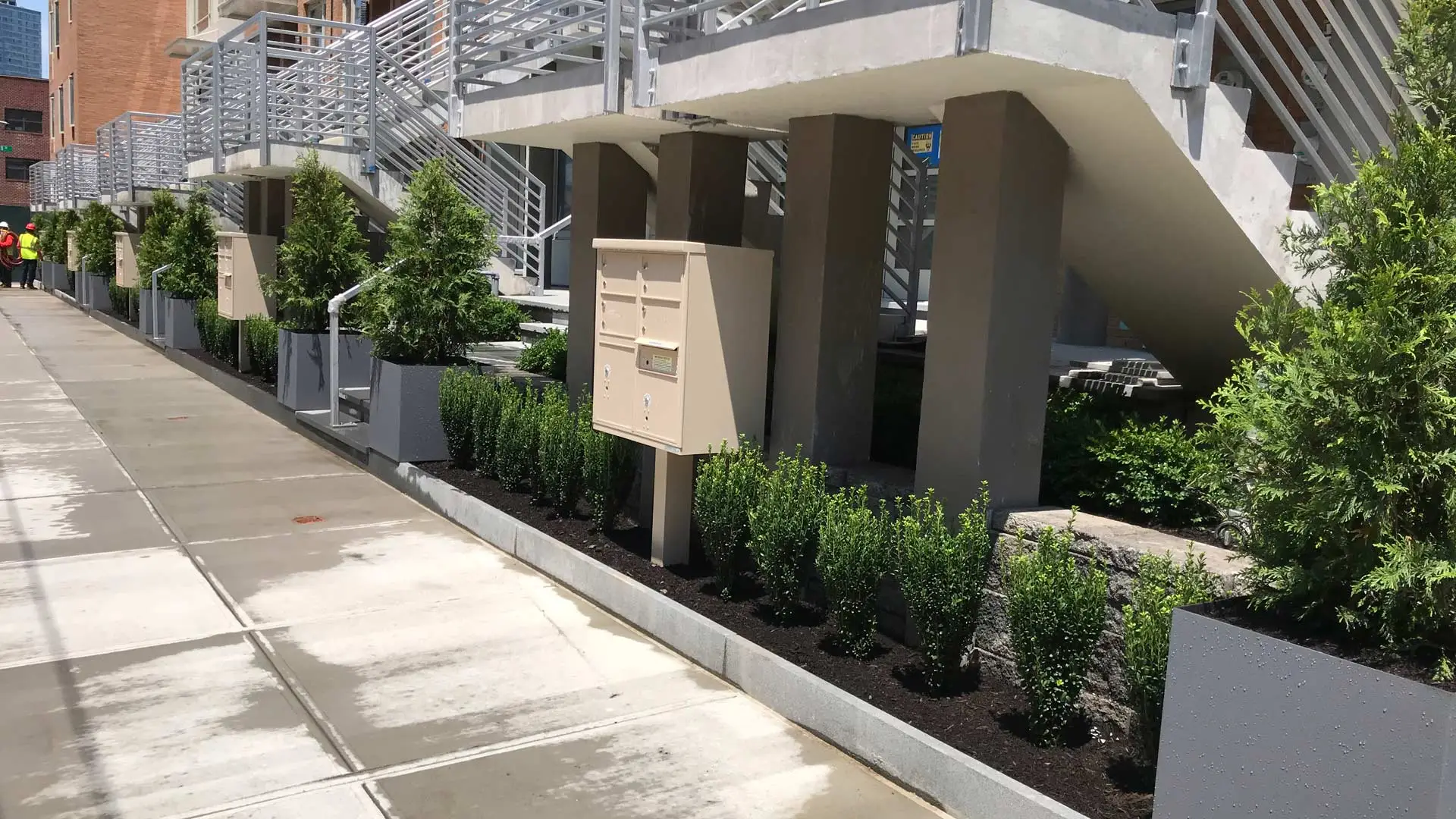 Landscape by stairs of a commercial building maintained in Edgewater, NJ.