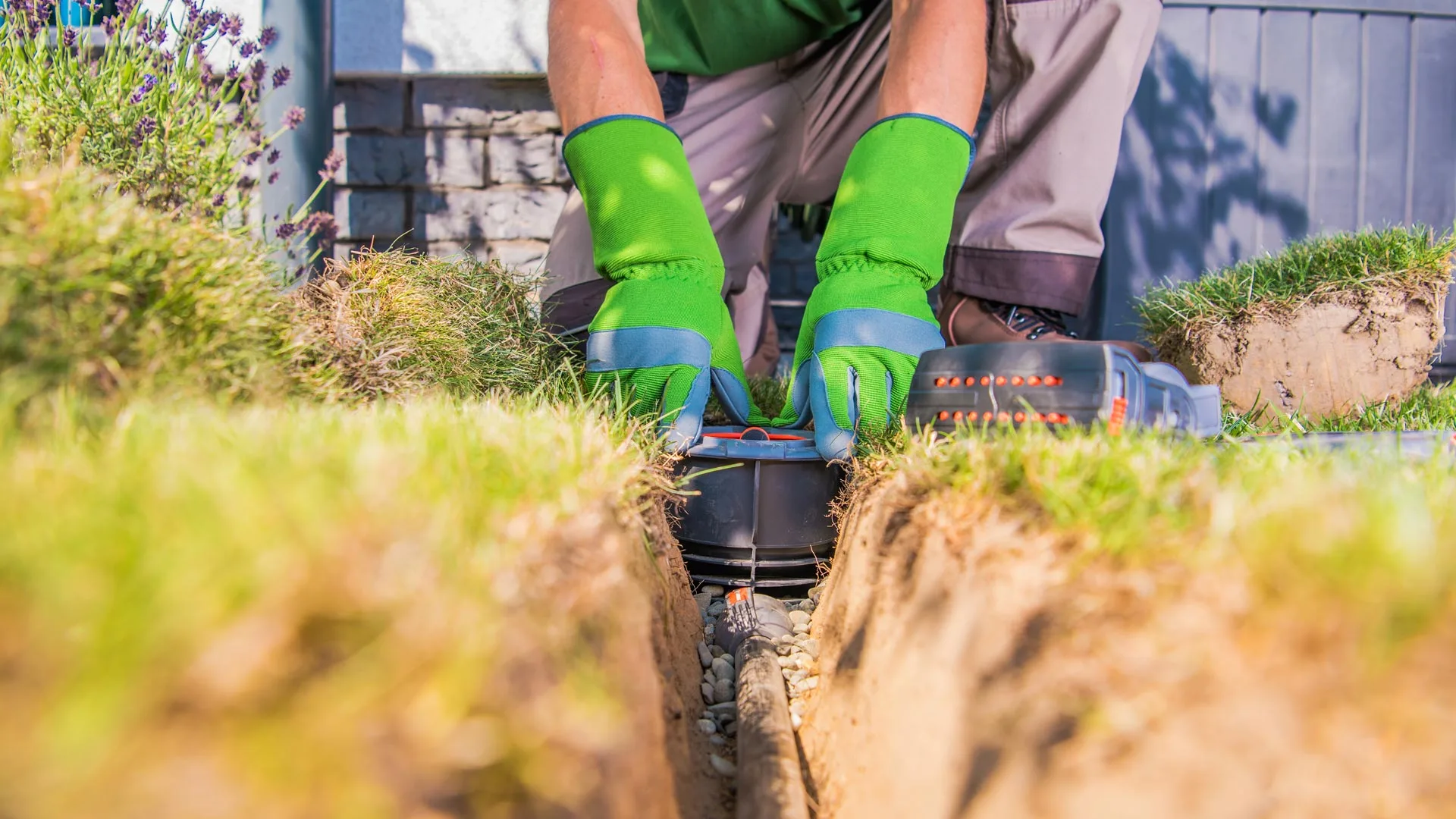 A professional installing an irrigation system in a lawn in The Bronx, NY.