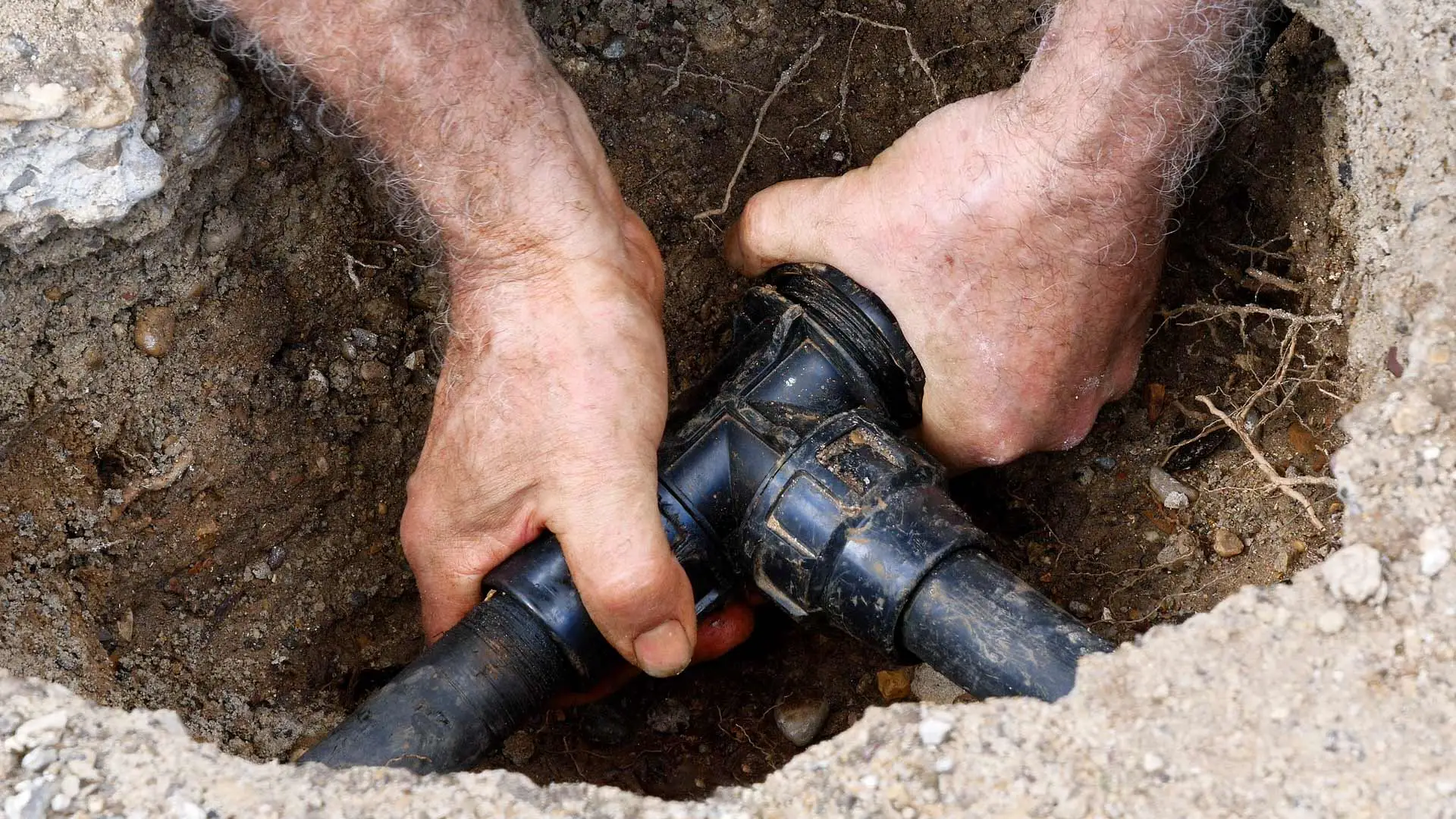 A technician repairing an irrigation system in Edgewater, NJ.