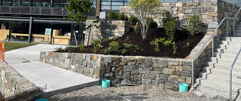 A retaining wall for landscape installed on sloped property in Alpine, NJ.