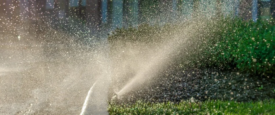 Sprinkler system watering grass in Connecticut.